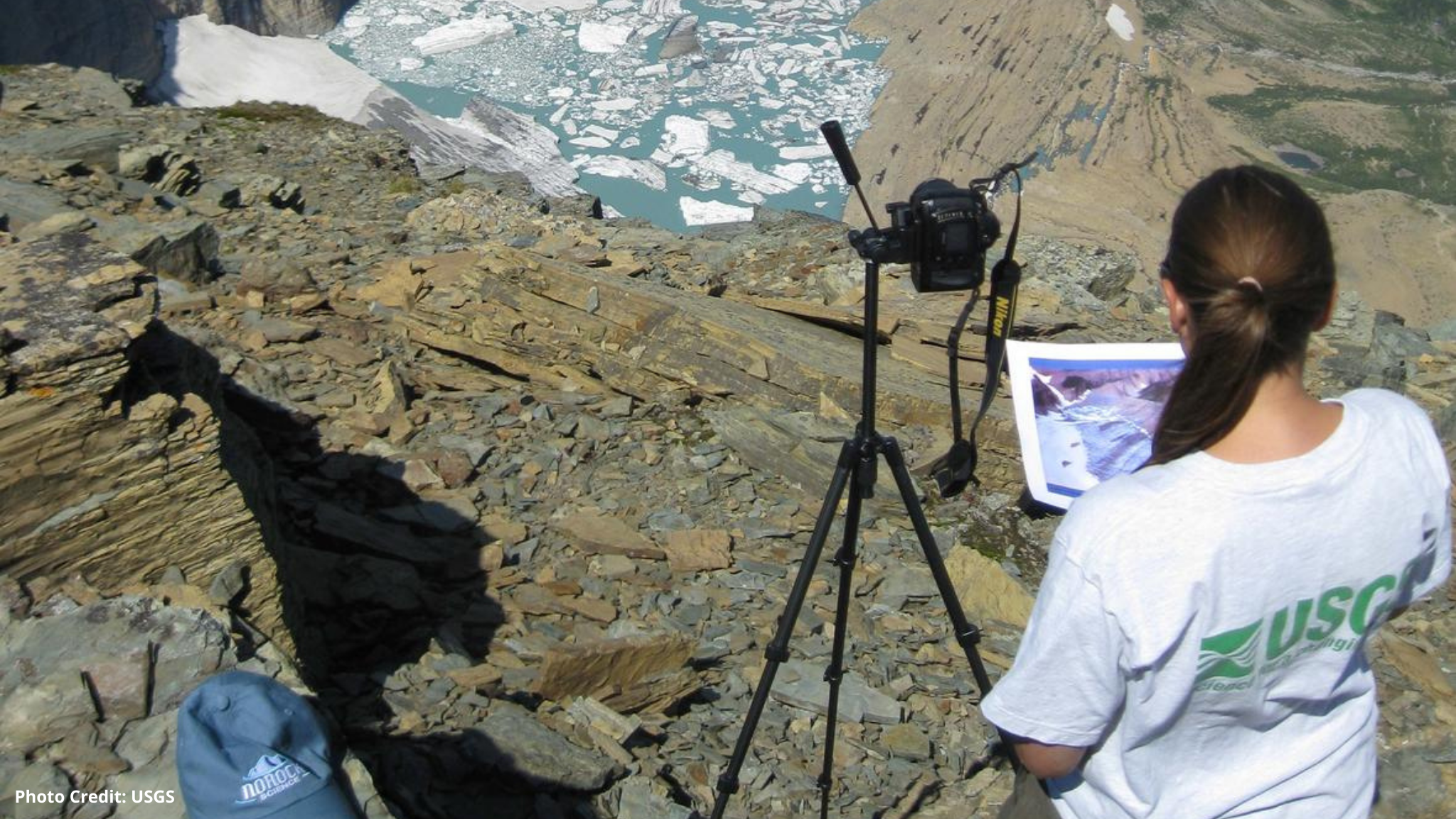 A USGS scientist takes data on a glacier