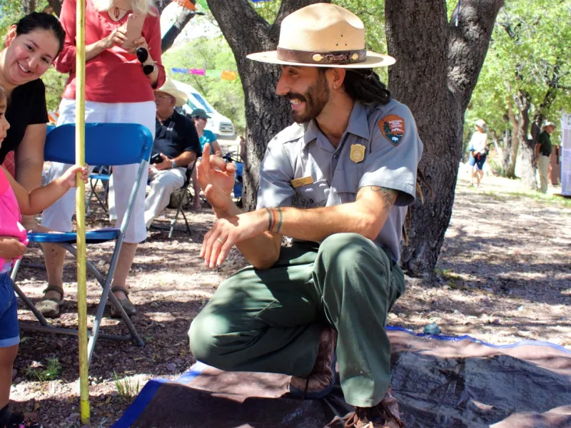 A national park ranger talks with a student