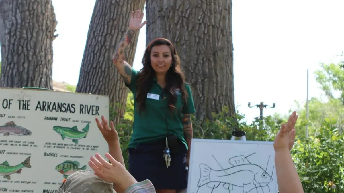 An environmental educator at the Nature and Wildlife Discovery Center asks kids to raise hands during a program