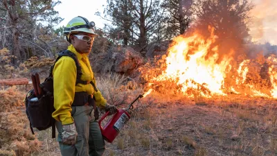 A wildland firefighter uses a drip torch 