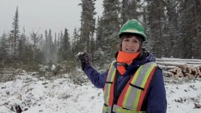 A chief forester explains her role in logging while standing in front of a logging operation in the winter