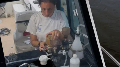 An environmental scientist with the EPA conducts an experiment while on a boat in the Chesapeake Bay