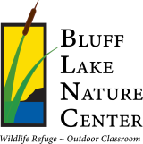 A green cattail against a yellow sky background and a blue lake with the text Bluff Lake Nature Center to the right