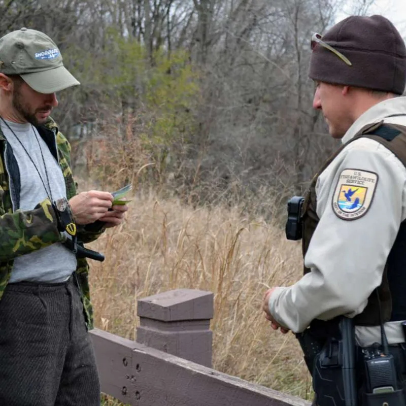 A conservation officer checks a hunting license