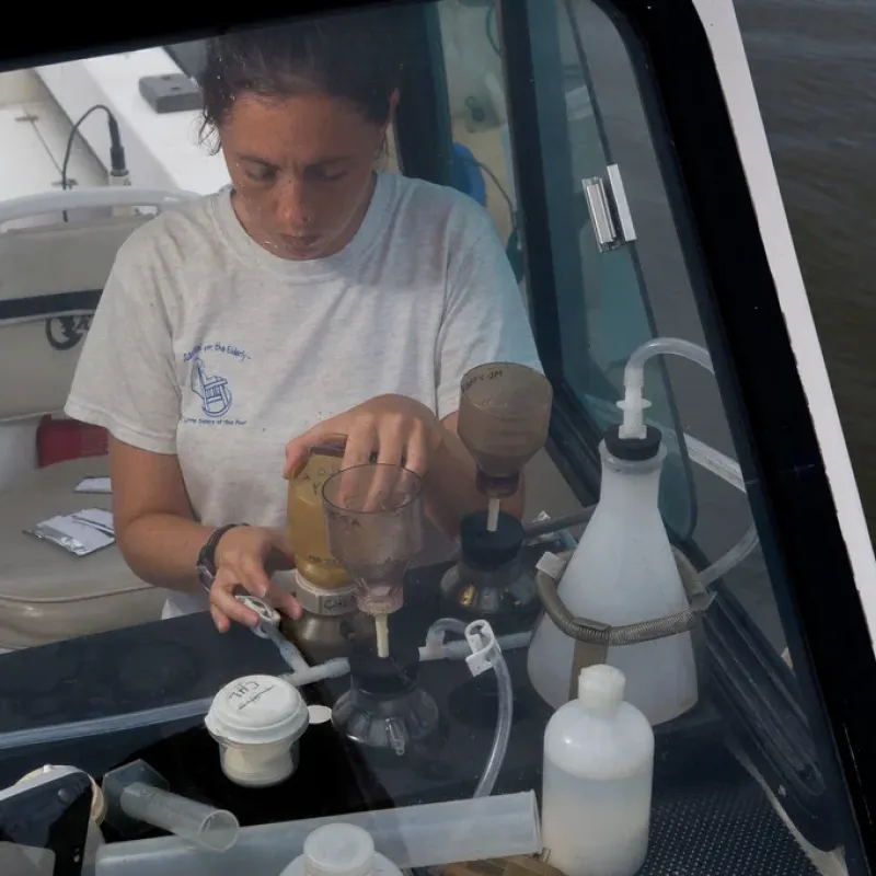 An environmental scientist with the EPA conducts an experiment while on a boat in the Chesapeake Bay