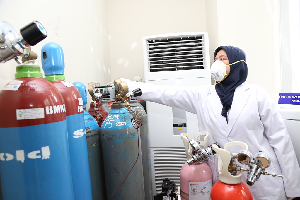 An atmospheric scientist checks the gauges on her equipment.