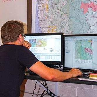 A GIS specialist creates a map on the computer